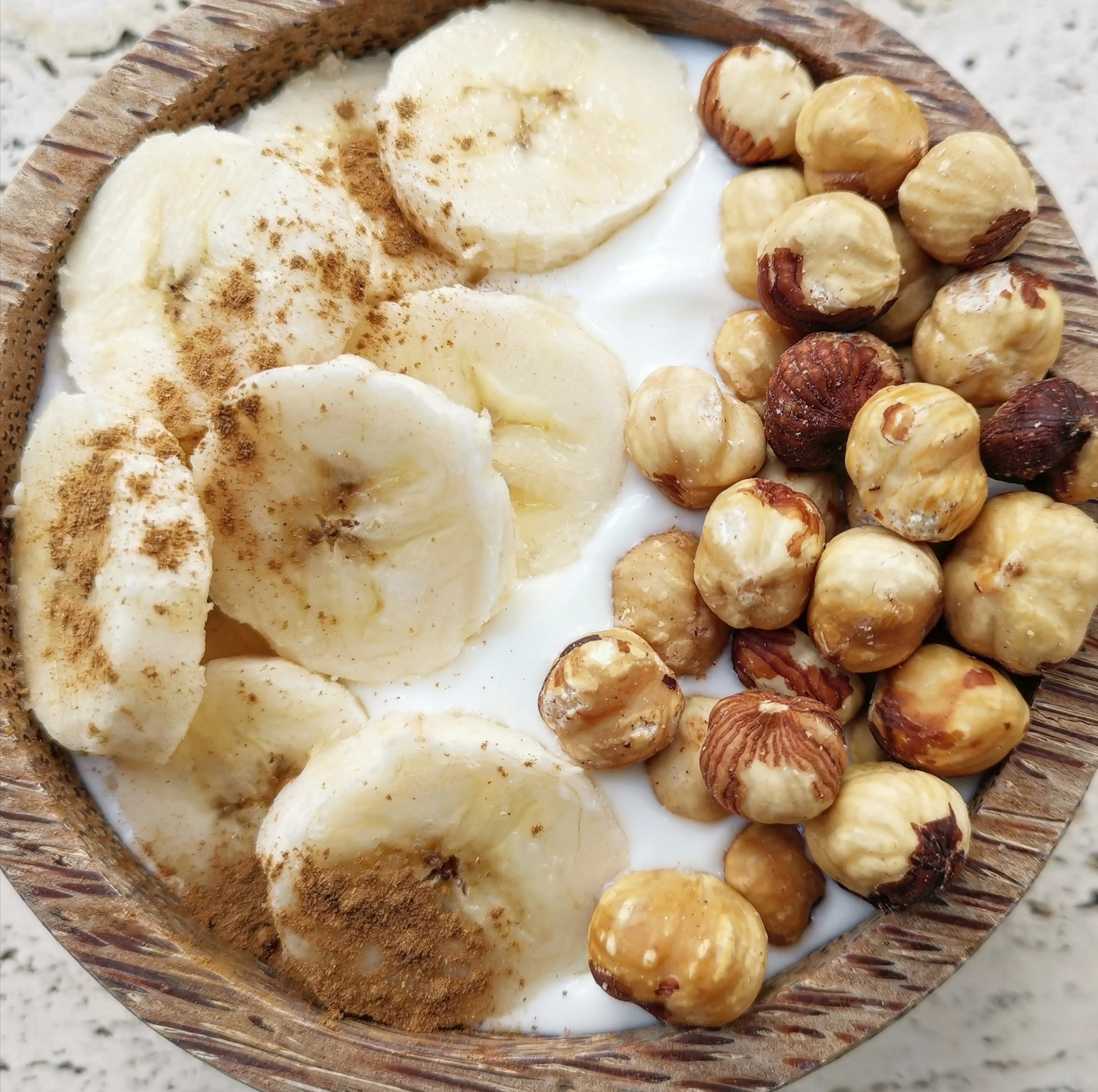 Yogurt Bowl with Banana, Cinnamon and Toasted Hazelnuts