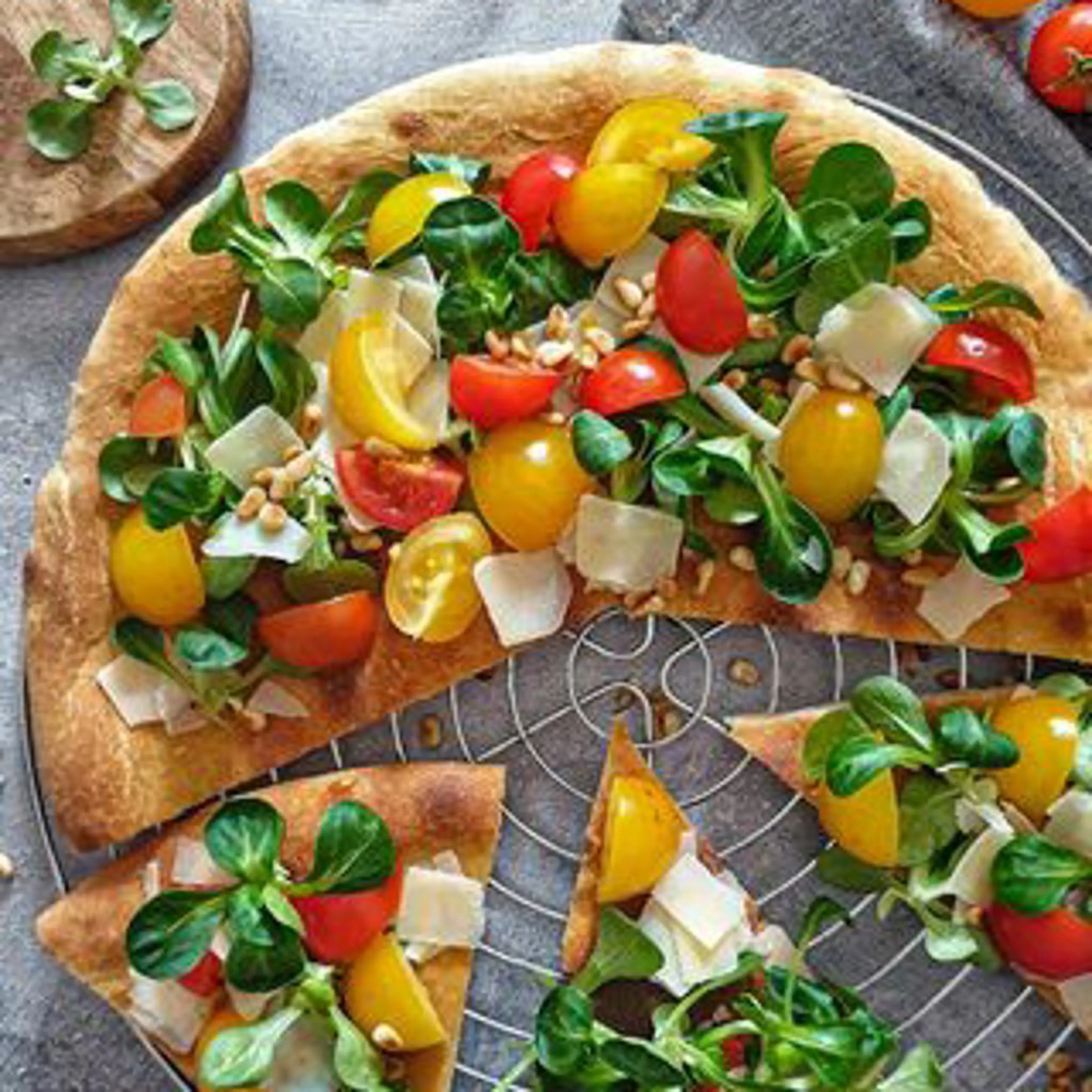 Pizza with cherry tomato and grana salad