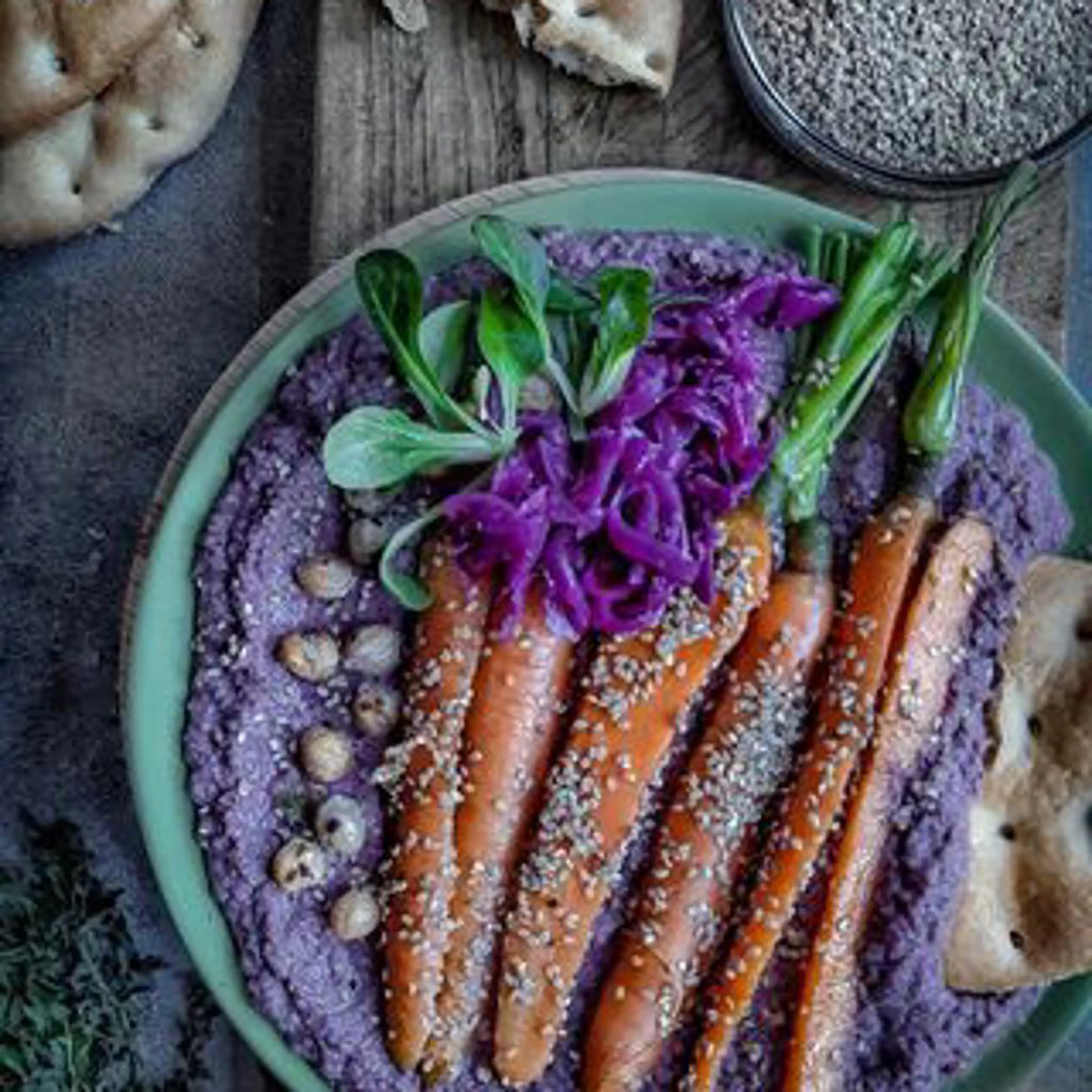 Purple hummus with sesame baby carrots