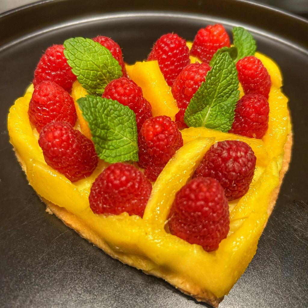 Almond shortcrust pastry, lemon cream with mango and raspberries