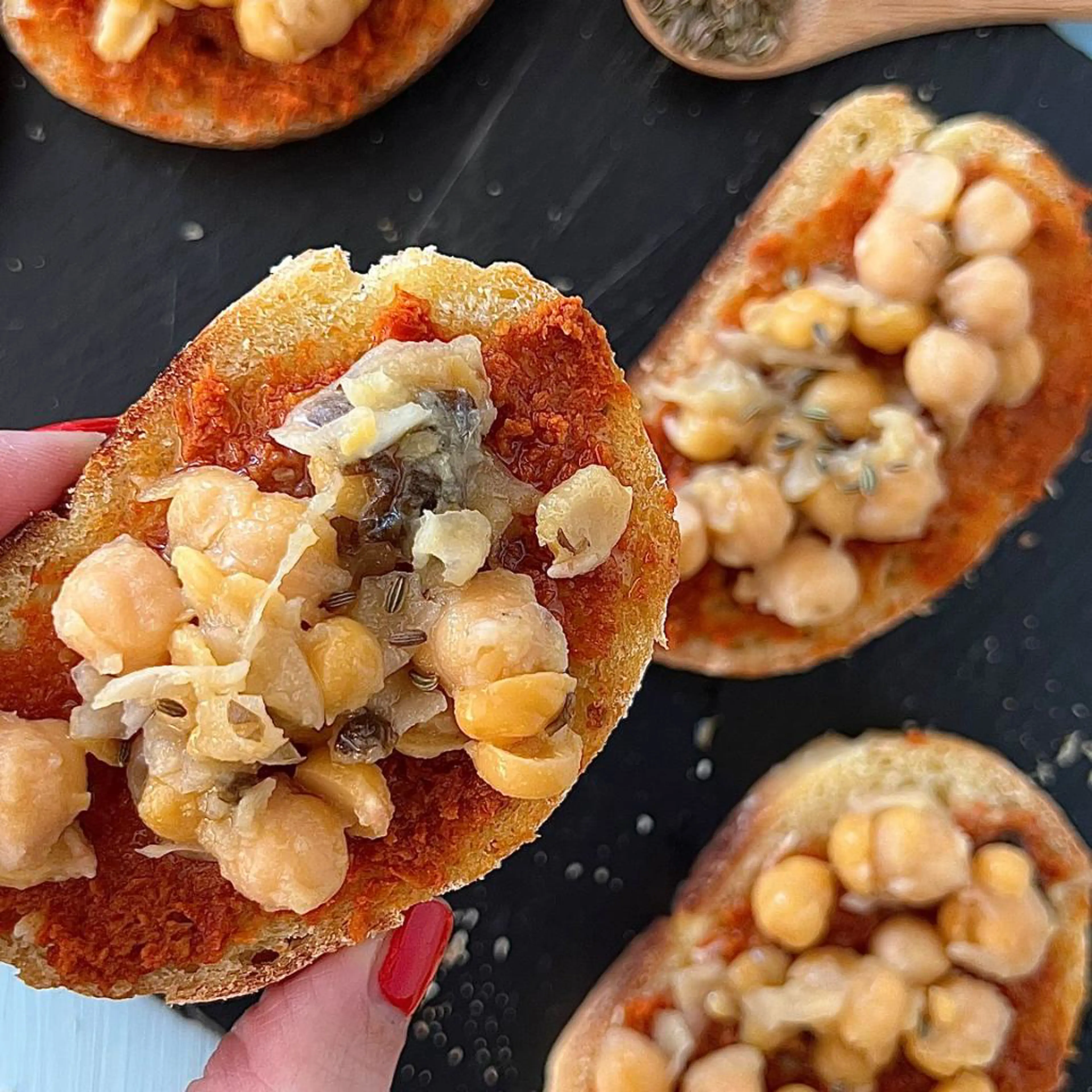 Homemade bread bruschettas with chickpeas, sun-dried tomatoes and fennel