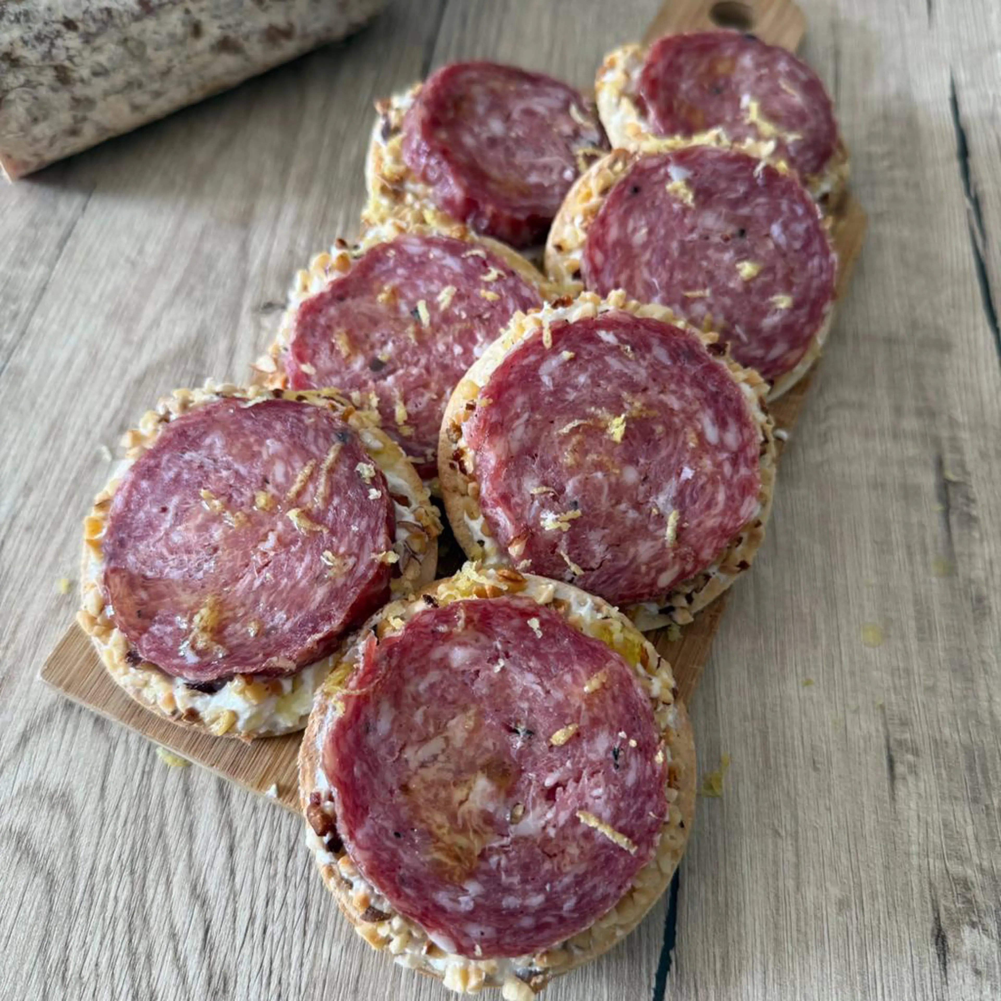 Crispy piadina tartlets with truffle salami, ricotta and hazelnuts