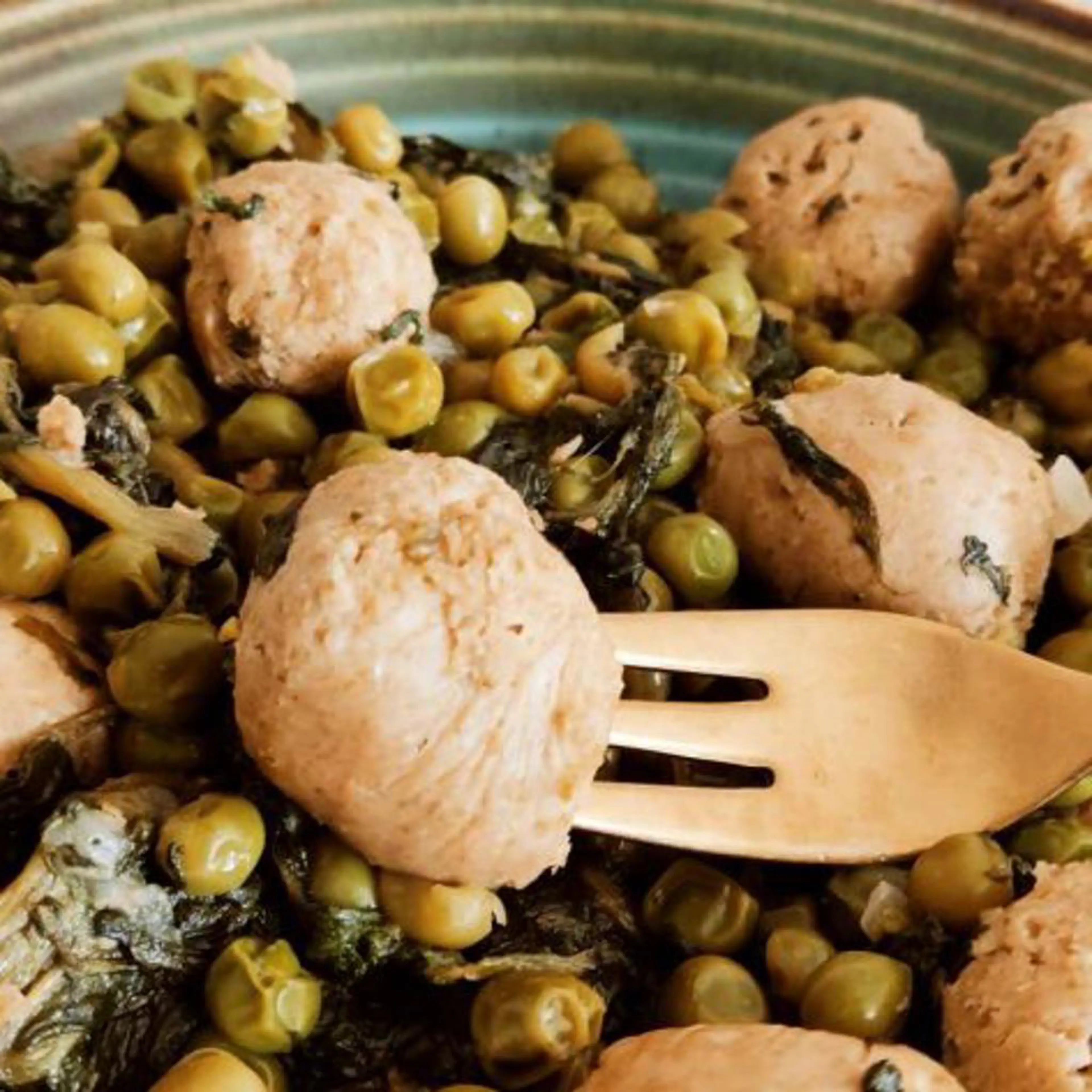 Vegan sausage meatballs with peas and spinach