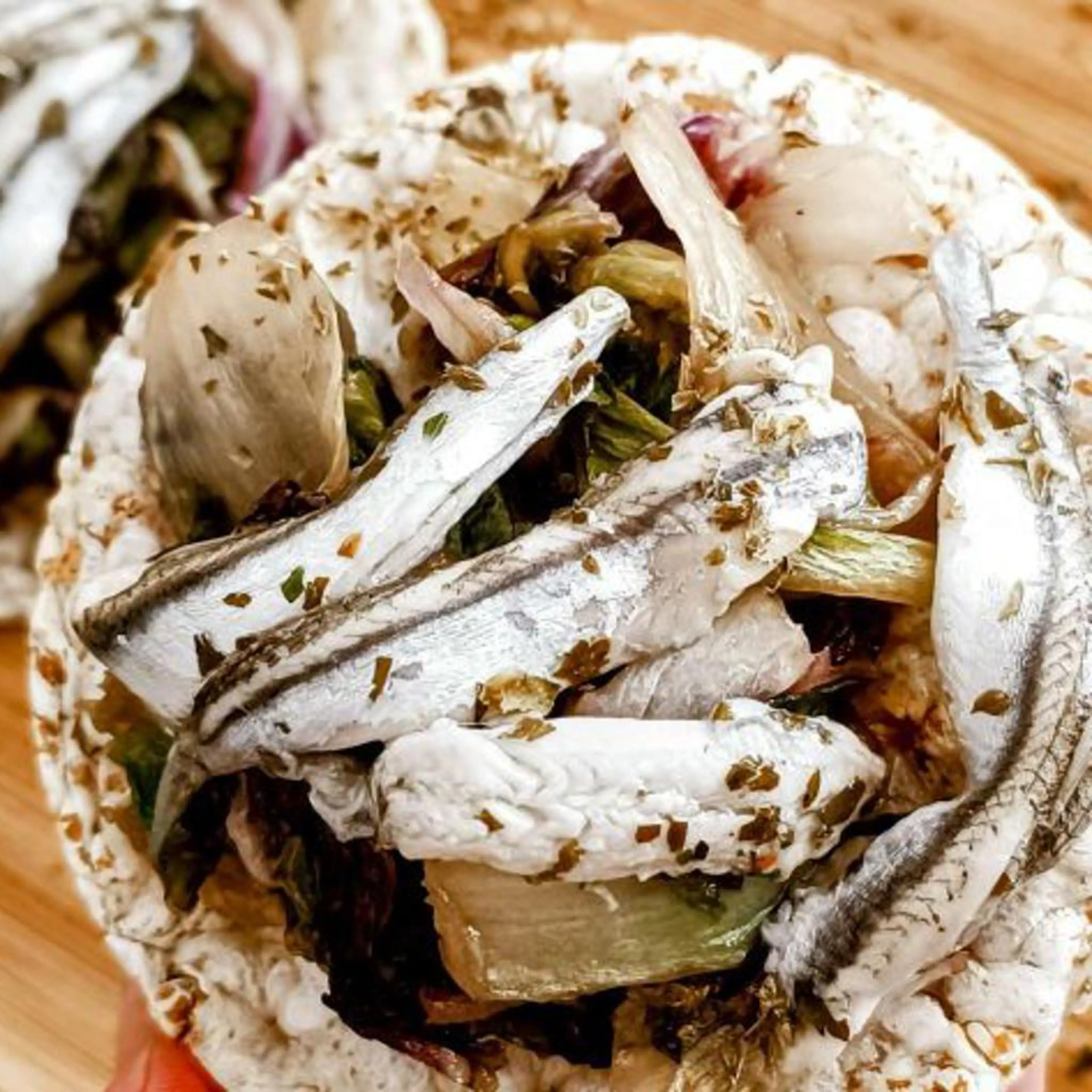 Spelt cracker bruschetta with marinated anchovies and vegetables